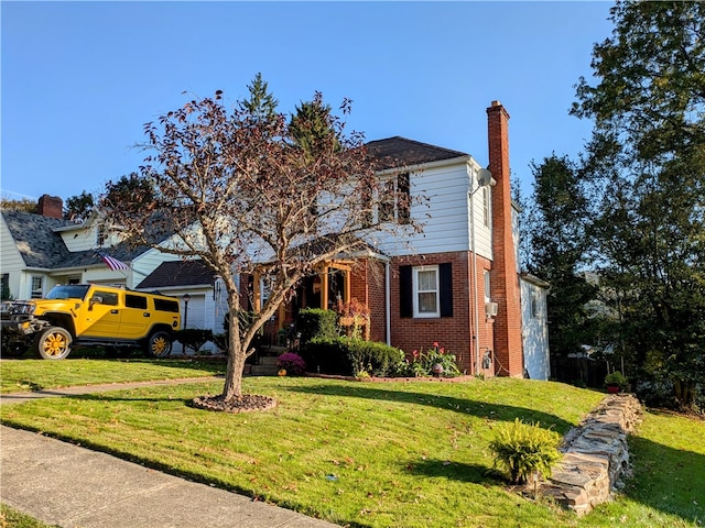 front of property featuring a front yard and a garage