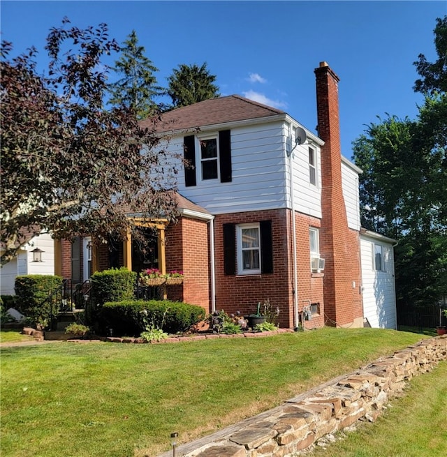 53 Orchard Pl, Bradford City, PA 16701 - traditional home with a chimney, brick siding, and a front yard