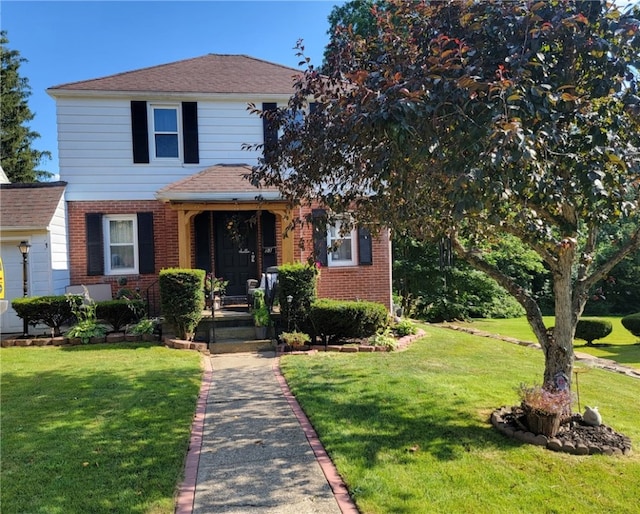 53 Orchard Pl, Bradford City, PA 16701 - traditional-style house featuring brick siding, a front yard, and a shingled roof