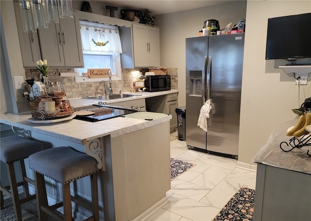 53 Orchard Pl, Bradford City, PA 16701 - kitchen featuring stainless steel refrigerator with ice dispenser, black microwave, a peninsula, light countertops, and a breakfast bar area