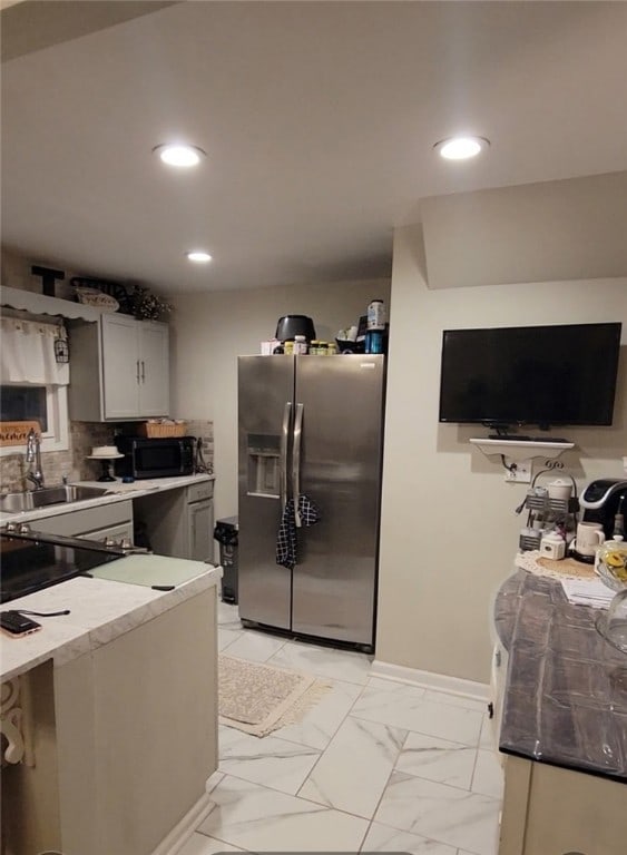 53 Orchard Pl, Bradford City, PA 16701 - kitchen with stainless steel fridge with ice dispenser, black microwave, light countertops, recessed lighting, and backsplash