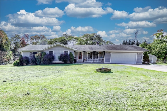 ranch-style house featuring a garage, a front lawn, and covered porch