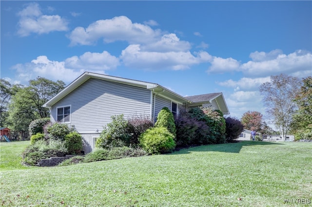 view of property exterior featuring a lawn