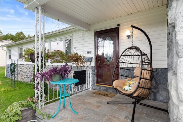 view of exterior entry with covered porch