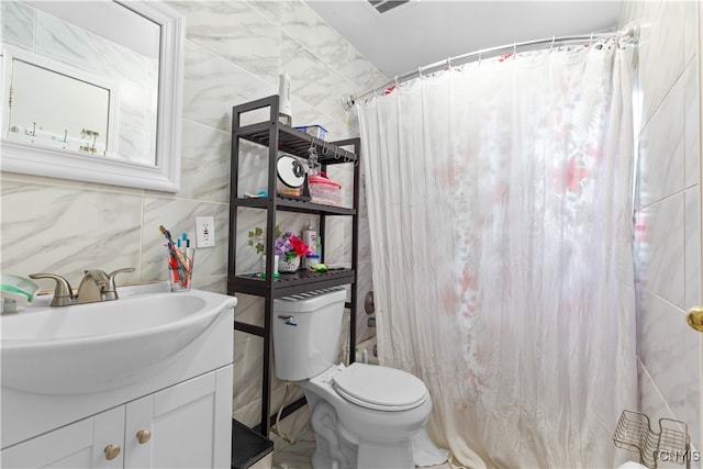 bathroom featuring walk in shower, vanity, tile walls, and toilet