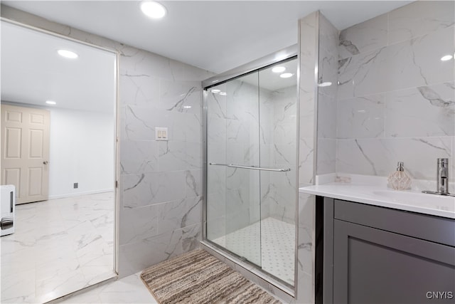 bathroom featuring vanity and a shower with shower door