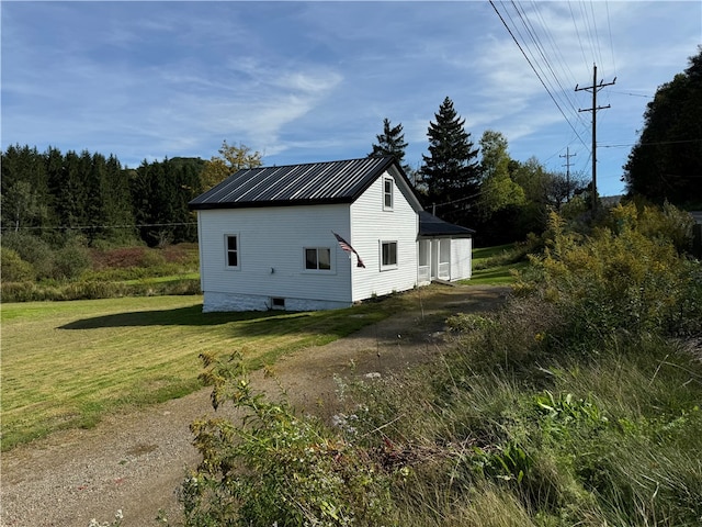 view of home's exterior with a lawn