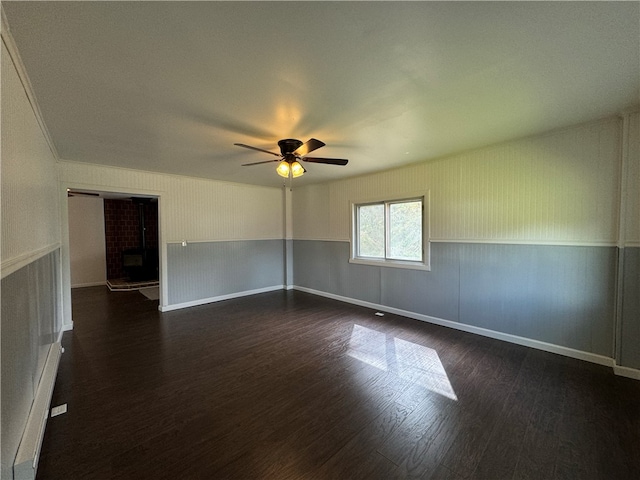 unfurnished room with ceiling fan and dark wood-type flooring