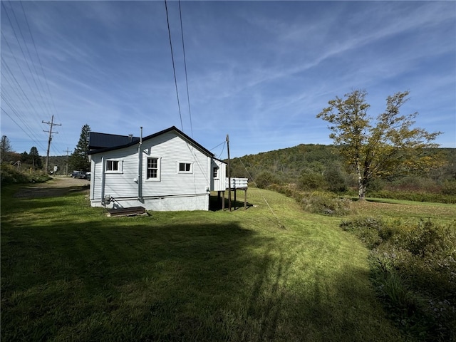 view of side of property with a lawn