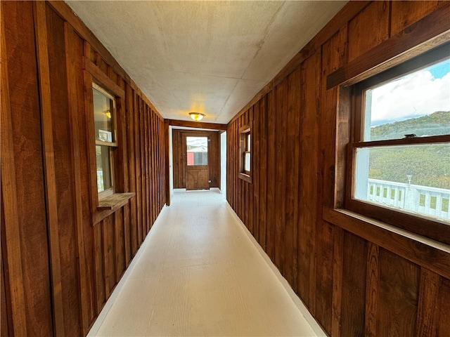 hallway with wood walls