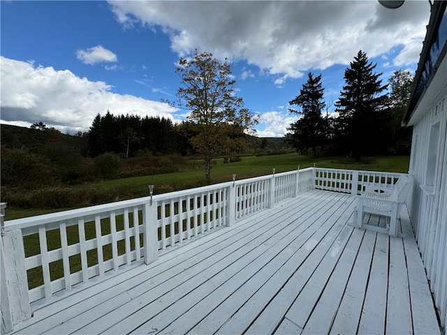 wooden deck featuring a yard