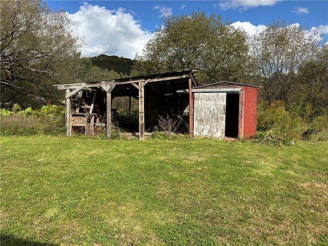 view of outbuilding with a yard