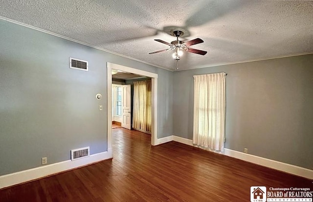 unfurnished room with ceiling fan, ornamental molding, a textured ceiling, and dark hardwood / wood-style flooring