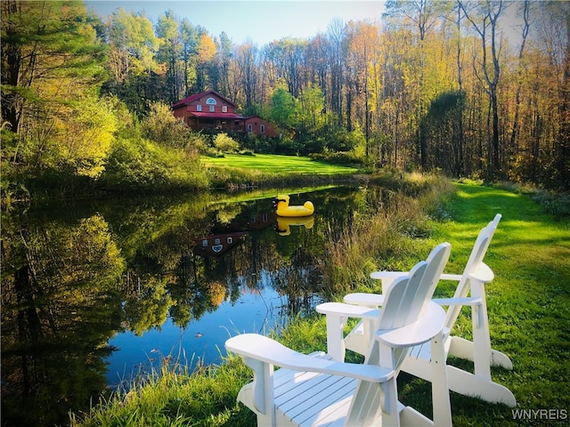 exterior space with a water view and a lawn