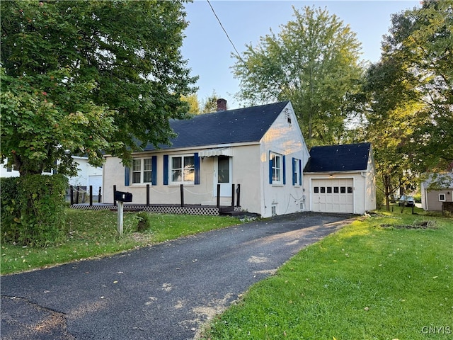 view of front of property with a front yard and a garage