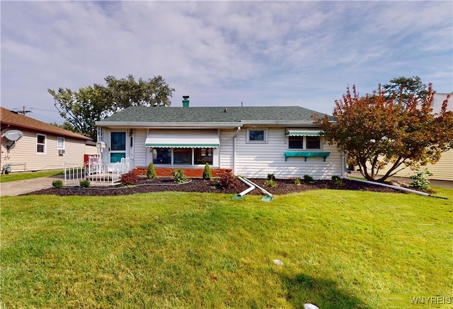 rear view of house featuring a lawn