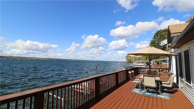 wooden terrace featuring a water view