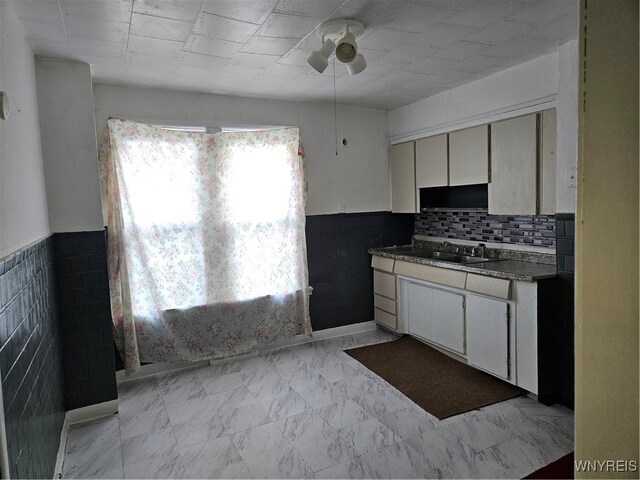 kitchen featuring white cabinets and sink