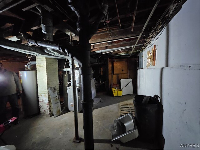 basement featuring water heater and heating unit