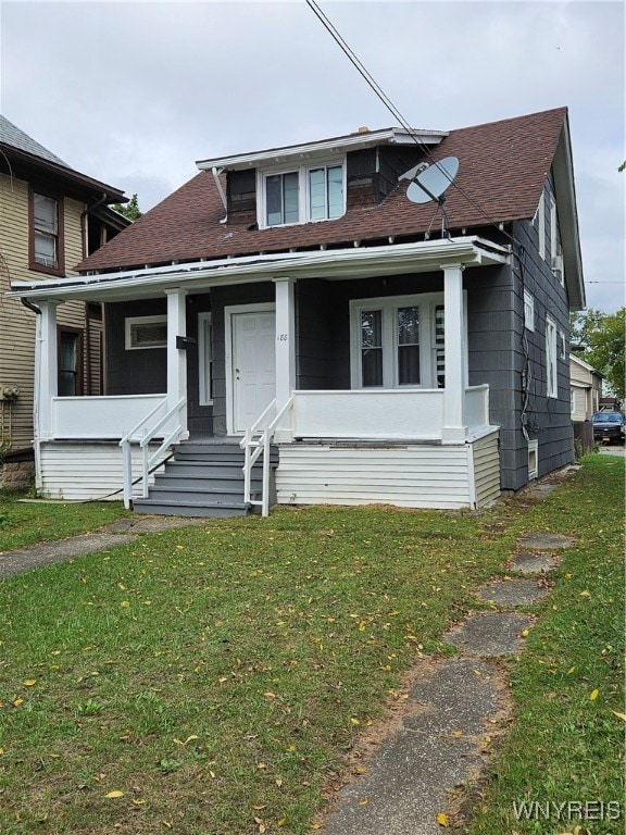 view of front of property with covered porch and a front yard