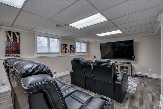 cinema featuring a drop ceiling and hardwood / wood-style floors