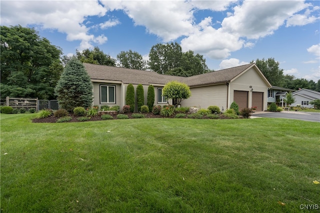 ranch-style house featuring a garage and a front lawn