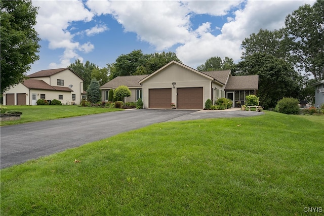 view of front of property with a front yard and a garage