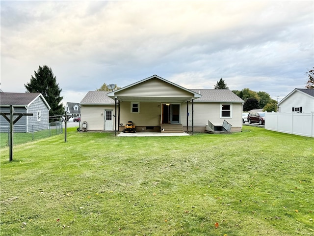 rear view of house featuring a yard and a patio area