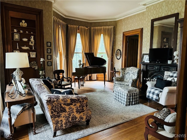 living area featuring ornamental molding, hardwood / wood-style flooring, and a fireplace