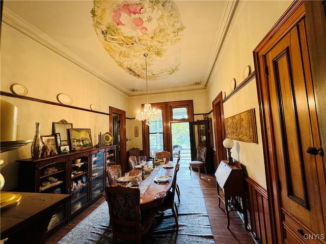 dining space featuring dark hardwood / wood-style floors, a chandelier, and ornamental molding