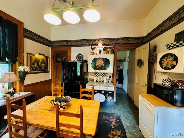 dining space featuring wood walls