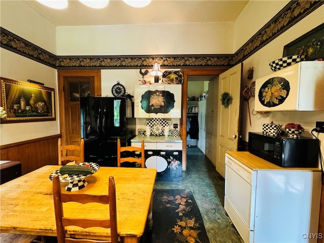 dining room featuring wooden walls