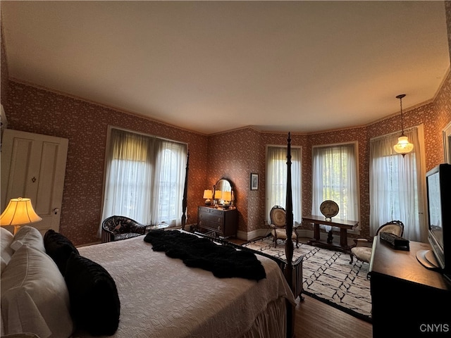 bedroom featuring crown molding and hardwood / wood-style floors