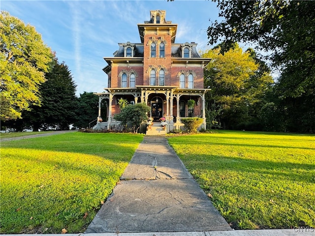 italianate-style house featuring a front lawn and covered porch