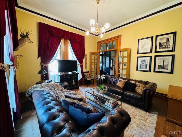 living room with a notable chandelier, hardwood / wood-style floors, and ornamental molding