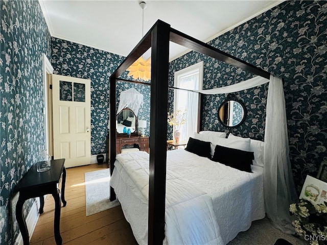 bedroom featuring hardwood / wood-style flooring and ornamental molding