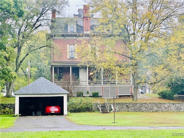 italianate house featuring an outdoor structure, a porch, a front yard, and a garage