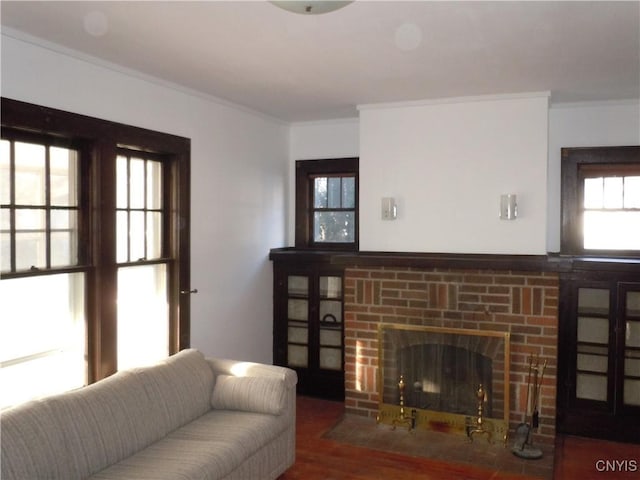 living room with a fireplace, wood-type flooring, and ornamental molding