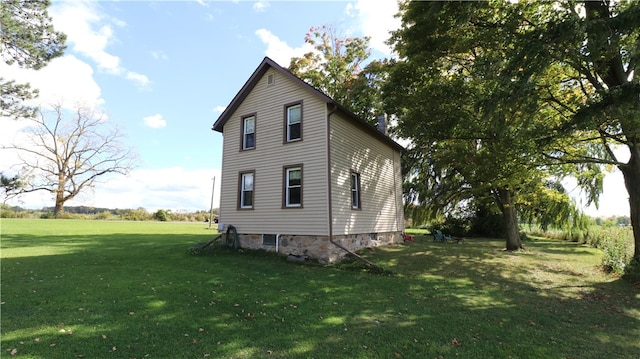 view of side of property with a lawn