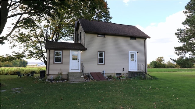 back of property featuring a lawn