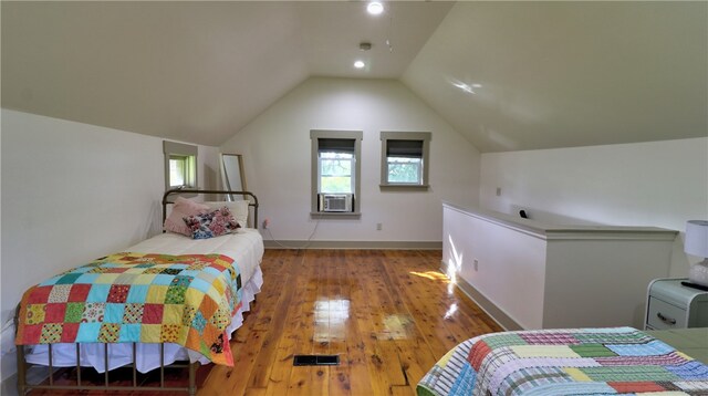 bedroom with hardwood / wood-style flooring and lofted ceiling