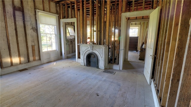 unfurnished living room with a fireplace and light hardwood / wood-style flooring