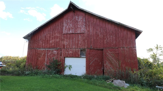 view of outbuilding with a lawn and a garage