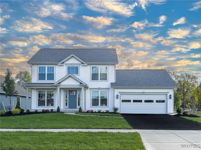 view of front of house featuring a yard and a garage