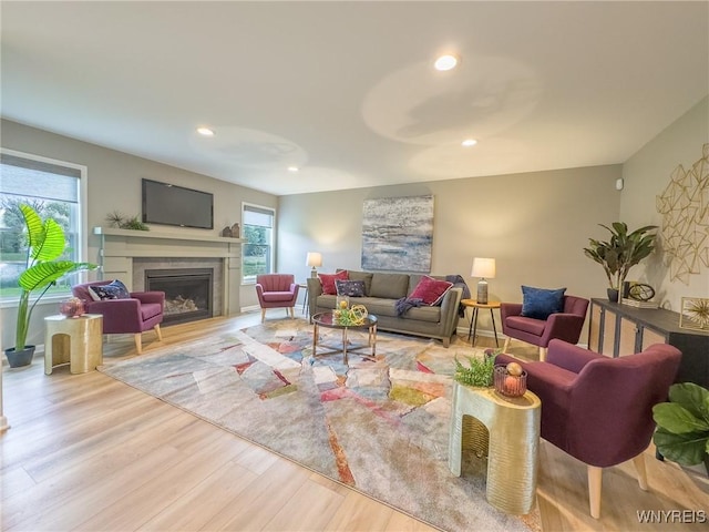 299 Cardinal Way N, Tonawanda, NY 14120 - living room with wood finished floors, a glass covered fireplace, and recessed lighting