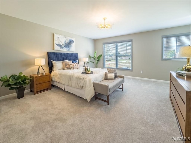 299 Cardinal Way N, Tonawanda, NY 14120 - bedroom with a chandelier, light colored carpet, multiple windows, and baseboards