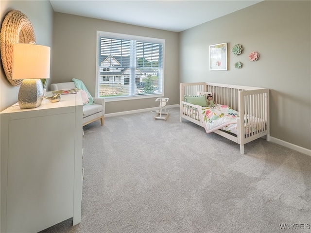 bedroom featuring carpet floors and a crib