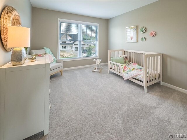 299 Cardinal Way N, Tonawanda, NY 14120 - bedroom featuring a crib, carpet flooring, and baseboards