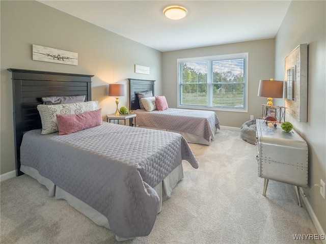 299 Cardinal Way N, Tonawanda, NY 14120 - bedroom featuring baseboards, light carpet, and a fireplace