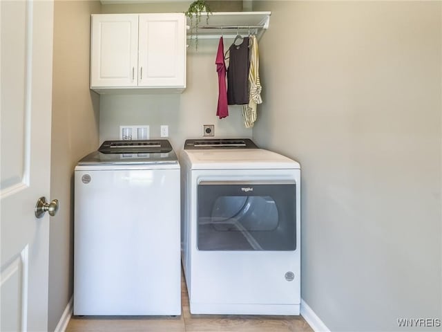299 Cardinal Way N, Tonawanda, NY 14120 - washroom featuring cabinet space, baseboards, light wood finished floors, and separate washer and dryer